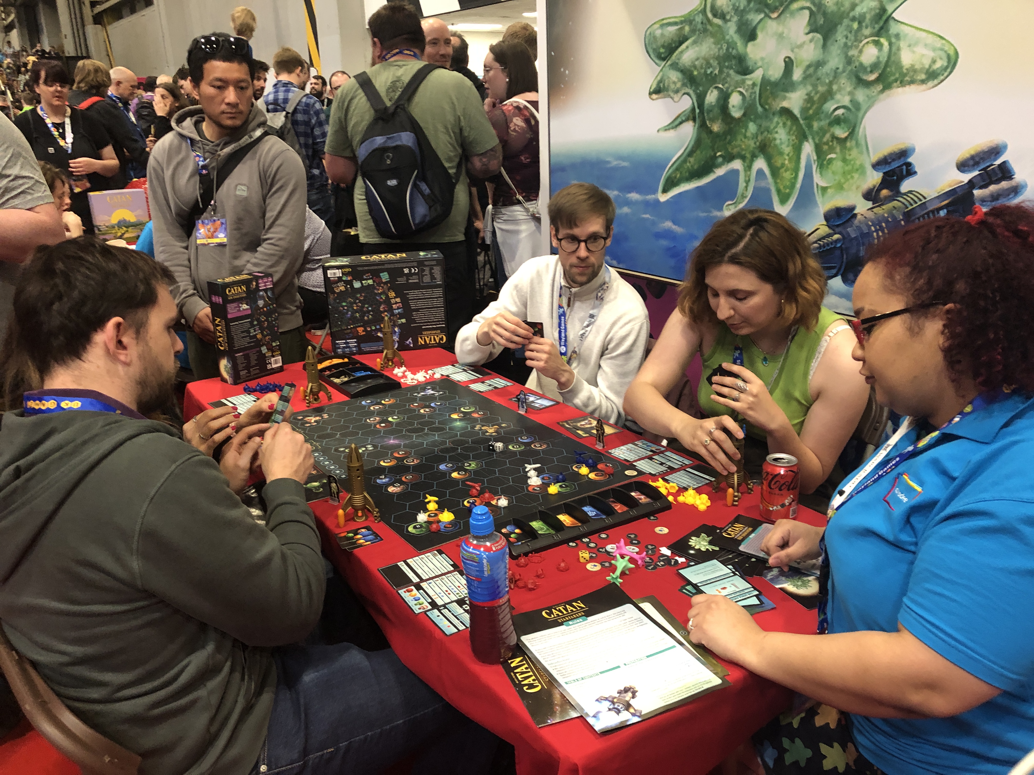 A group of people sitting at a table playing CATAN – Starfarers.